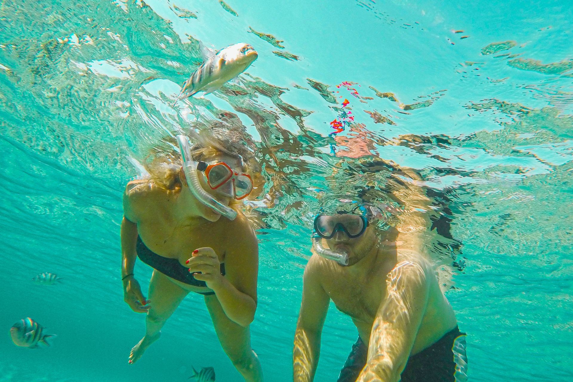 Happy couple enjoying snorkeling at private morning tour on sailing yacht with Maxie Sailing Curacao