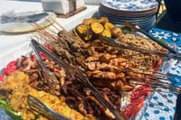 Enjoy a fresh island BBQ lunch with grilled seafood, chicken satay and local sides during your tropical boat tour.