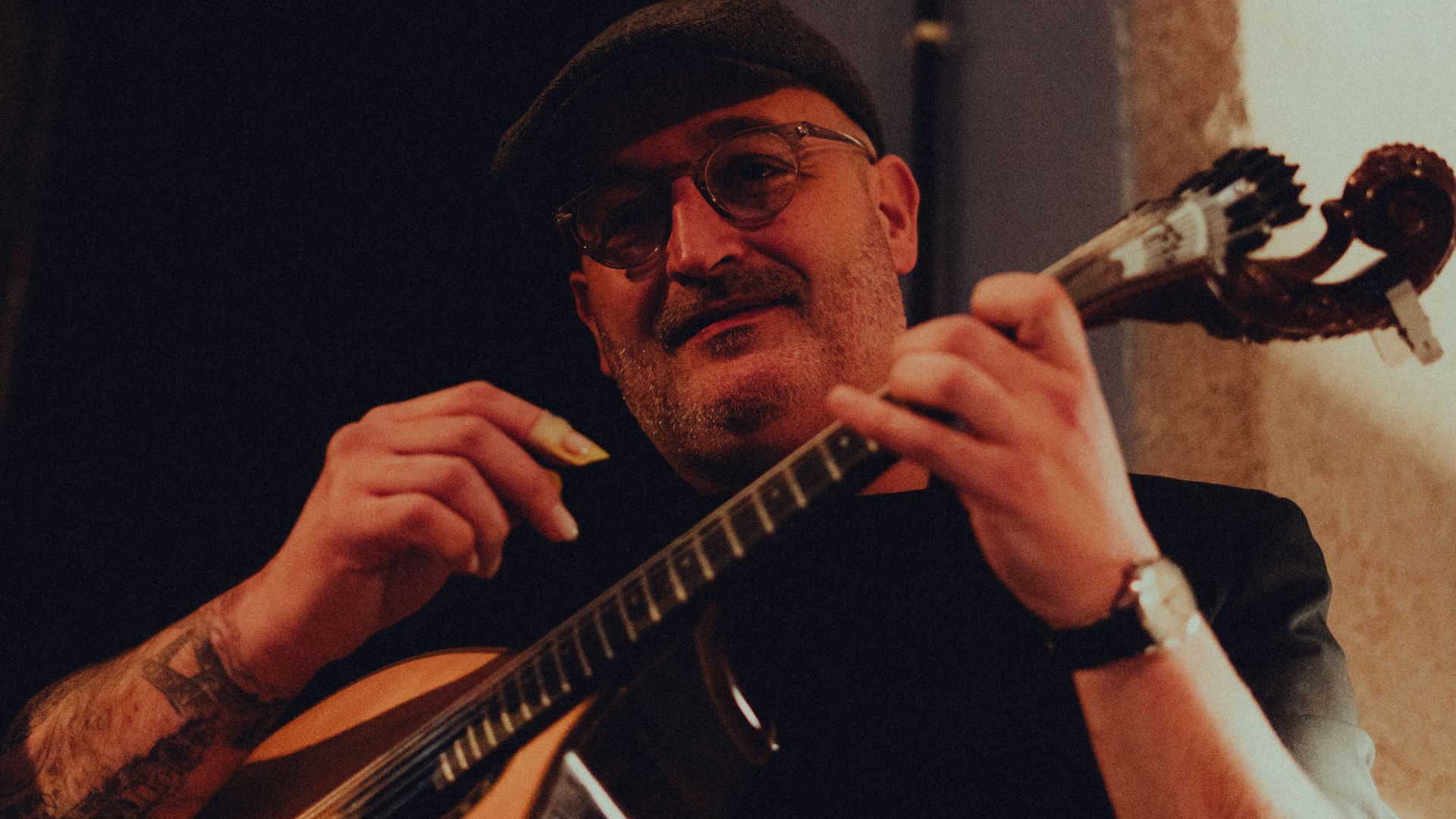 Portuguese guitar player performing live Fado music in Porto