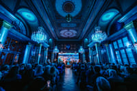 Live classical concert Vienna featuring blue atmosphere, crystal chandeliers, ballet projection and seated audience