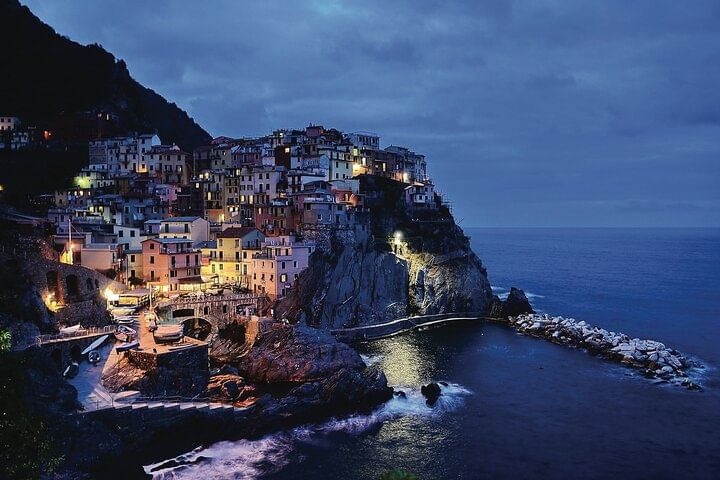 View of the coastal village of Manarola at nightime with all the lights in the village on 