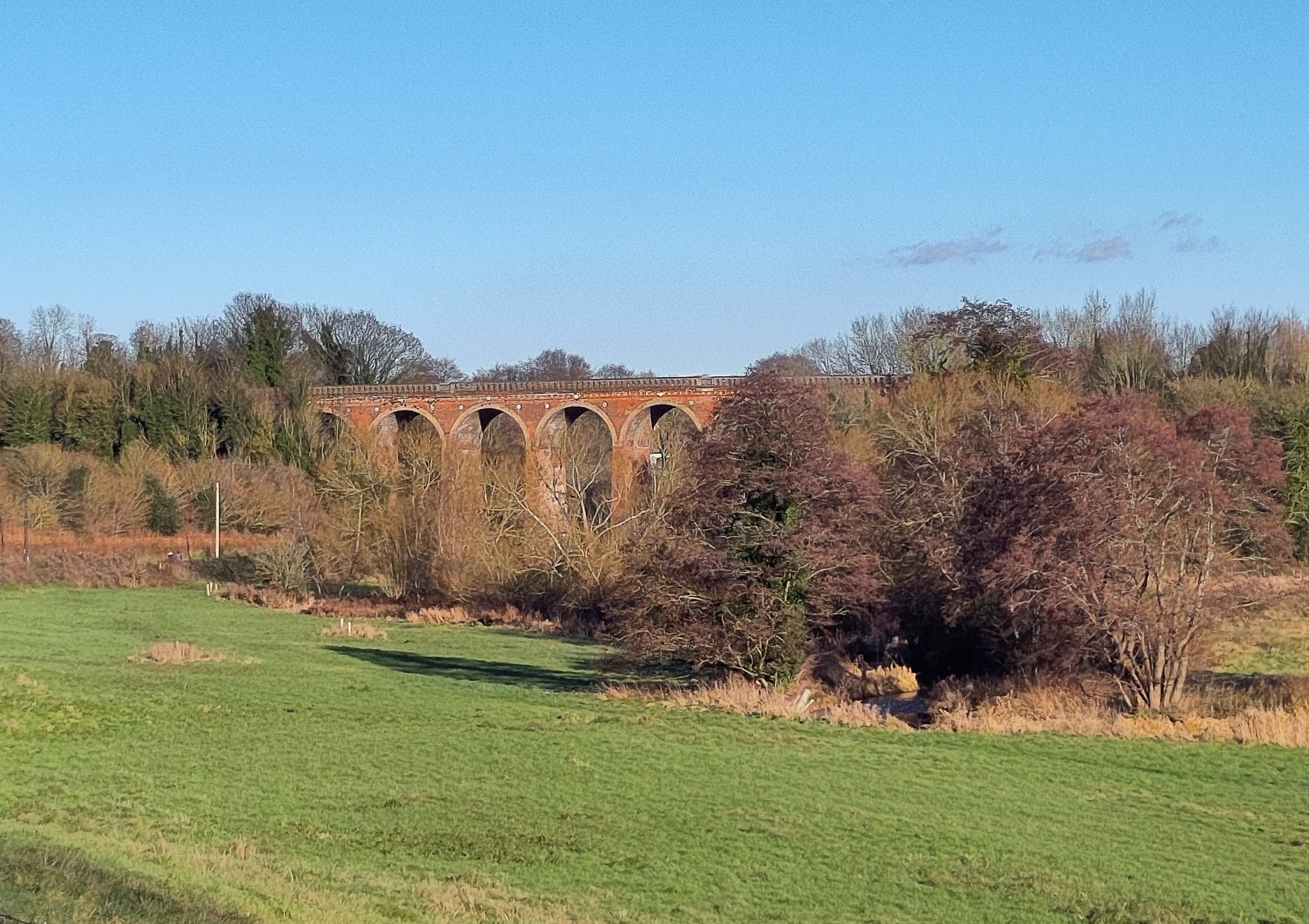 A multi arched brick built bridge spanning the valley
