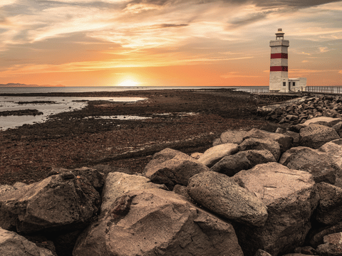 Magical view of the Garður lighthouse during a sunset