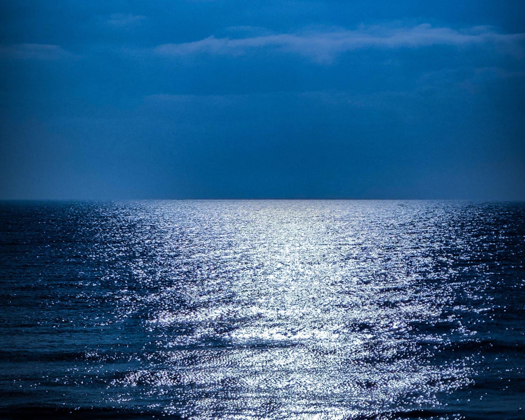 Ultra-bright sea, large body of water illuminated as if it were silver paper