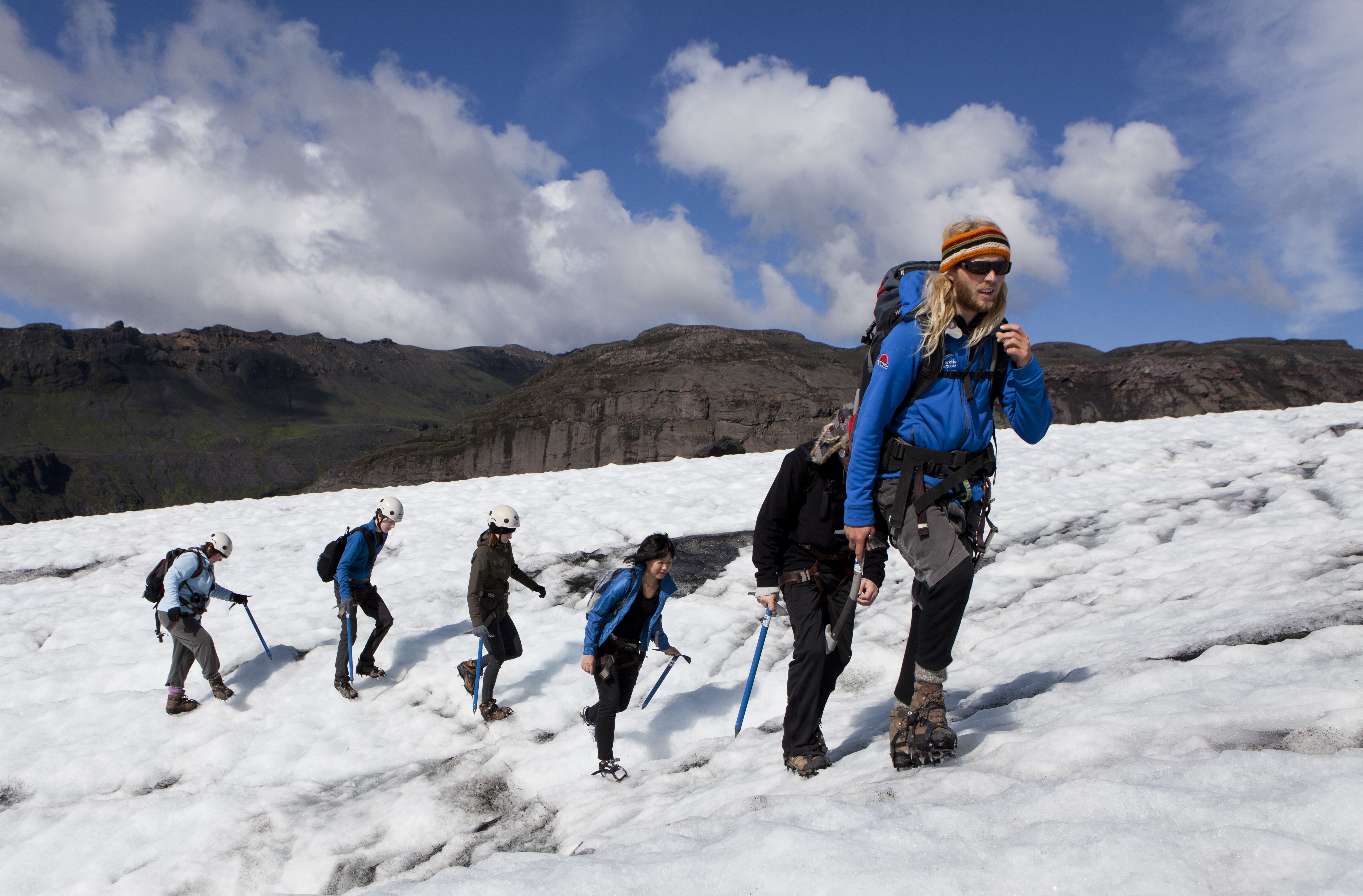 A small group of people hiking on the Glacier