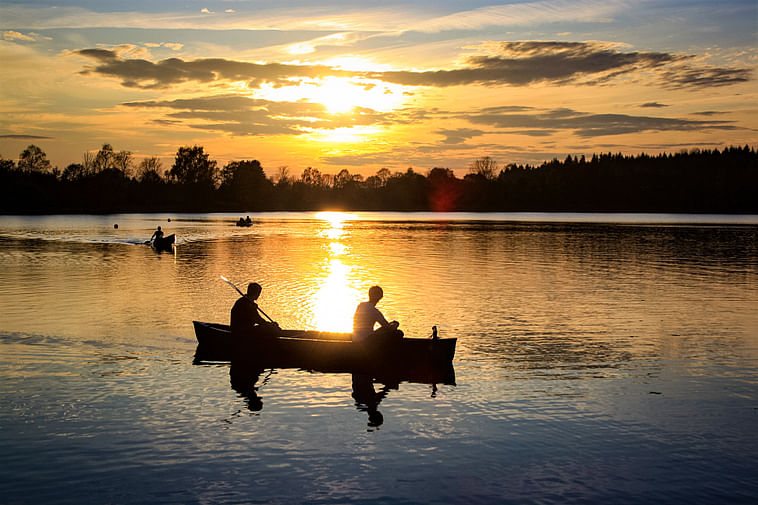 Canoeing under the Midnight Sun on a peaceful lake in Finnish Lapland
