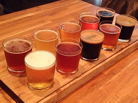 A sample platter with different types of beer displayed on it.