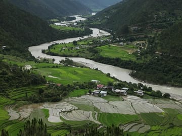 The fertile Punakha valley with Mochu River meandering through the village as seen from the picturesque Khamzum Yuellay Namgyel Chorten