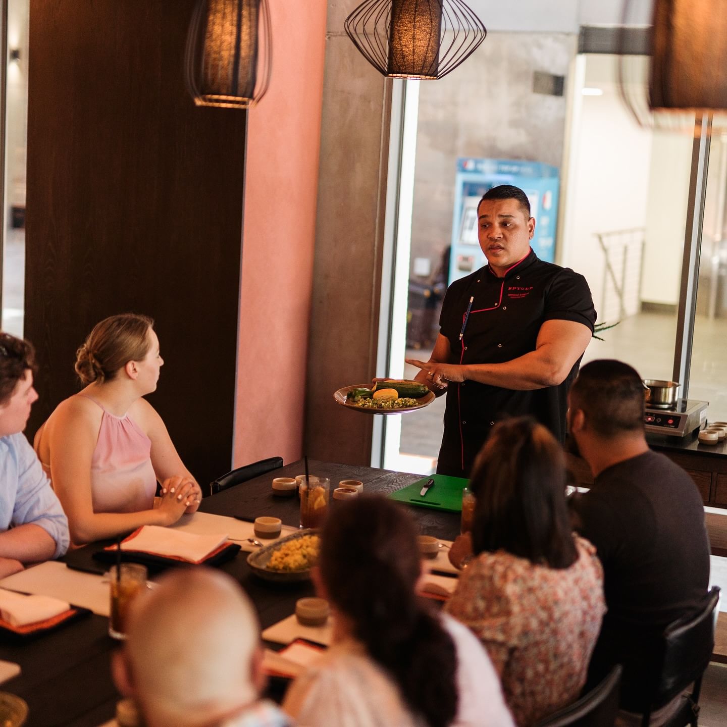 Chef at SPYCED Restaurant in Cape Town demonstrating Cape Malay cooking techniques to guests during the Cape Malay Cooking Experience
