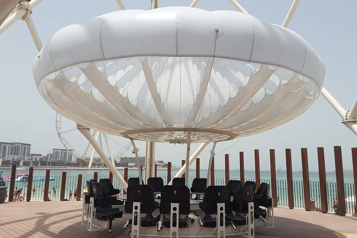 A close-up of a gourmet dish with the Dubai skyline in the background.