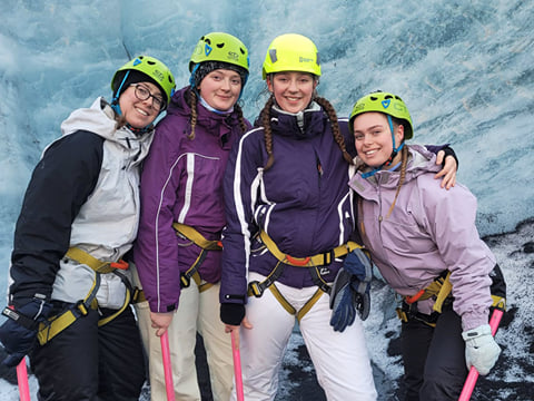Four girls pose for a photo shoot on the glacier