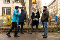 A group of guests actively listening to the guide telling a story