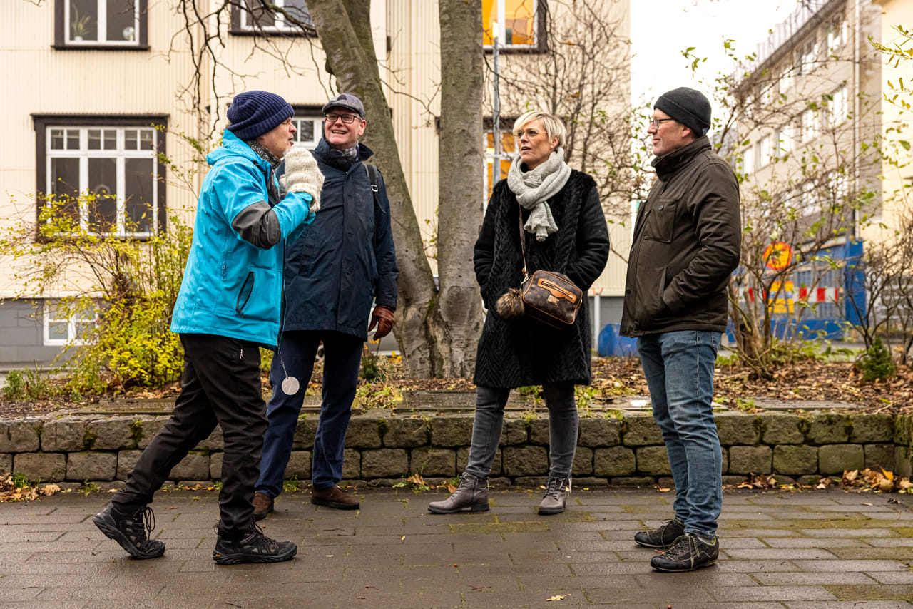 A group of guests actively listening to the guide telling a story