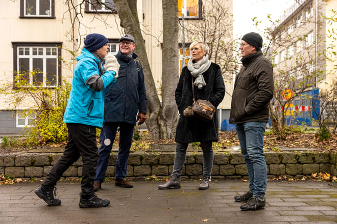 A group of guests actively listening to the guide telling a story