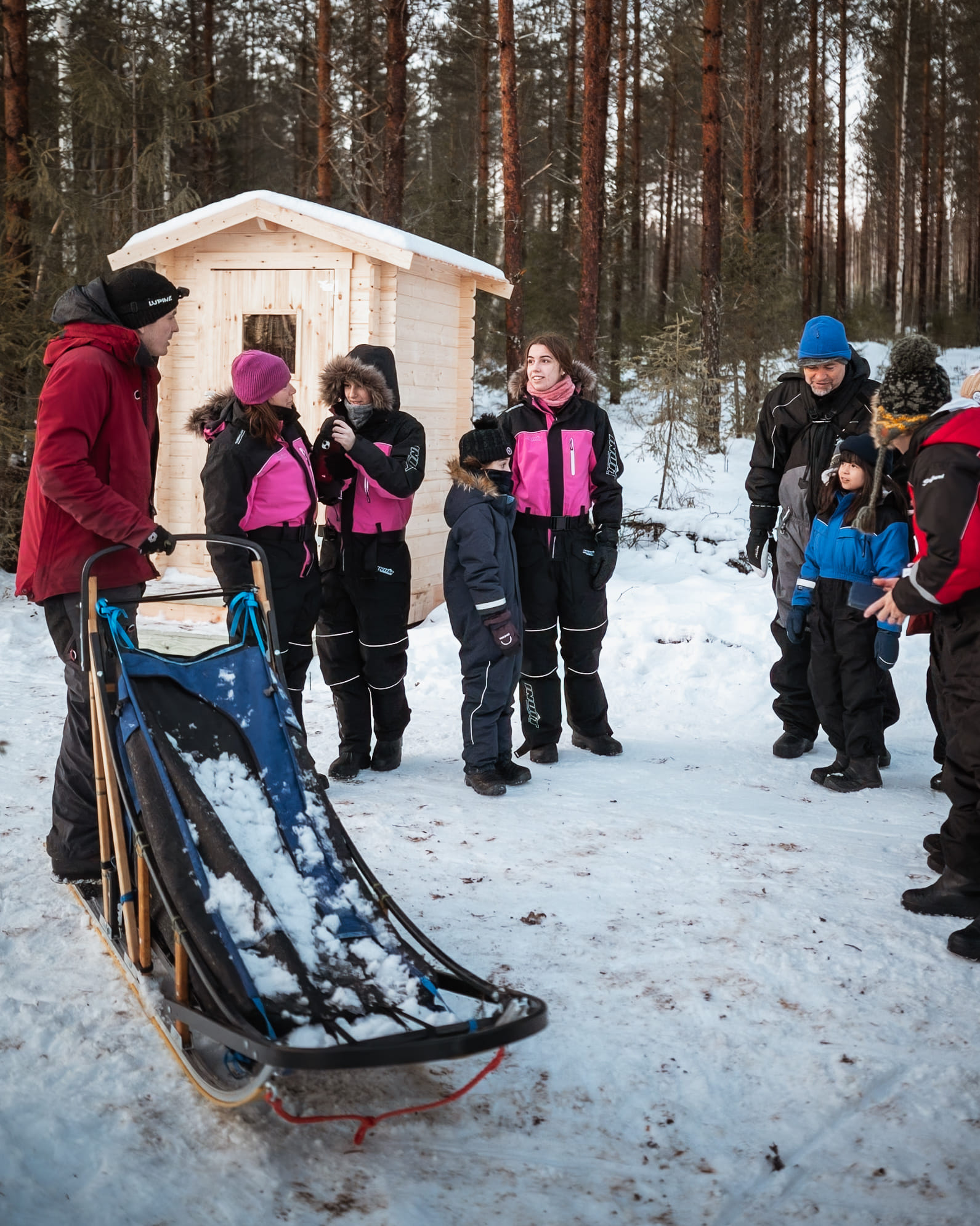 A group of participants preparing for the Kuoksa Husky & Snowmobile Adventure in Rovaniemi with StayLapland.