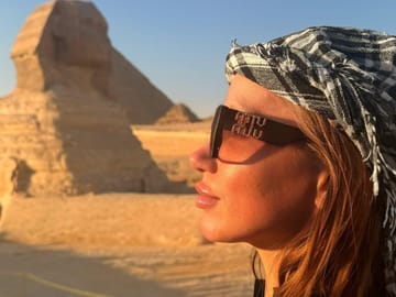 Guest standing near Sphinx, guardian of pyramids