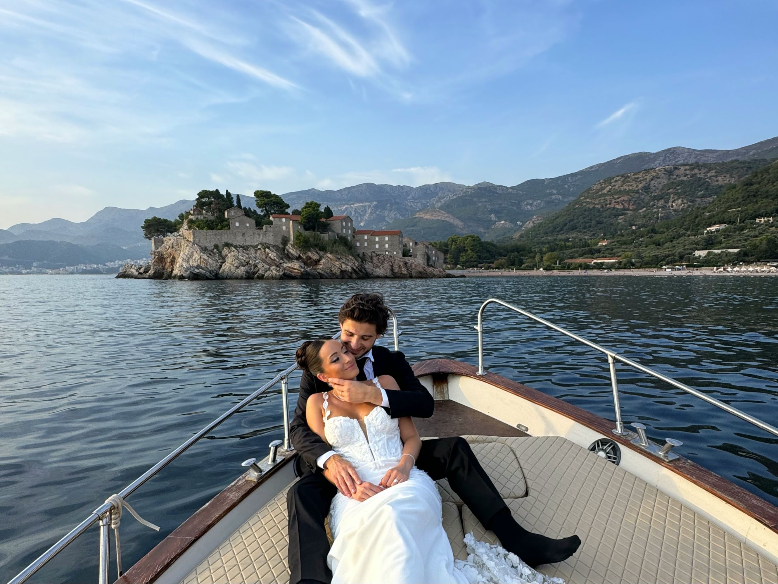 A couple sitting side by side, pointing at the horizon and admiring the breathtaking scenery.