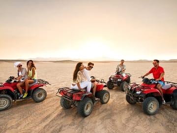 Quad bike ride qatar Dune bashing desert safari ATV inland sea by falcon tours