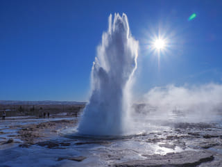 Majestic picture of the geyser Strokkur erupting in a sunny day