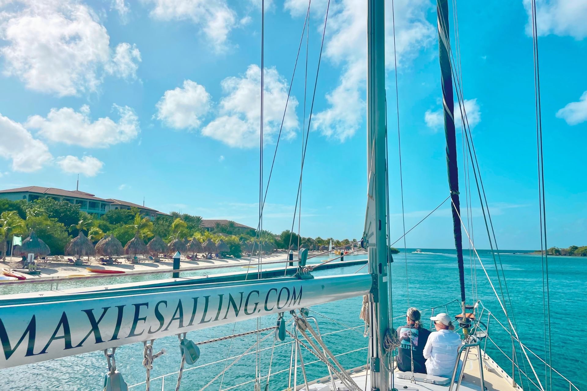 Happy couple sailing along Sandals Curacao during private snorkeling tour on sailing yacht with Maxie Sailing Curacao
