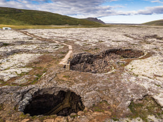 An elevated view of the caves only entrances. The accessible main entrance is visible behind the smaller "skylight".