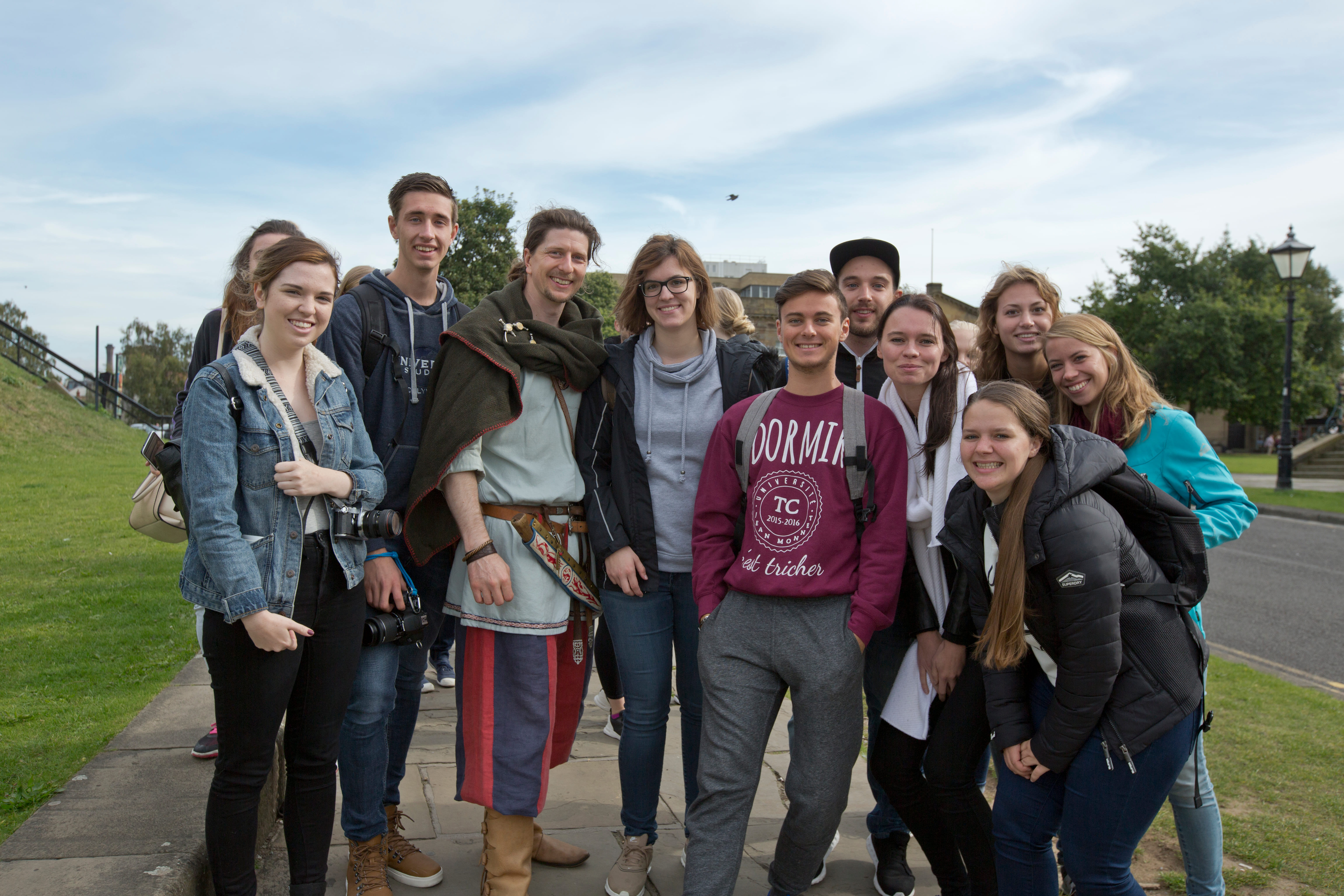 A viking tour guide with a group of international students, at Clifford's Tower, York.