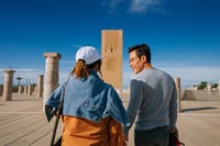 Travelers discovering the Hassan Tower and its esplanade full of history.
