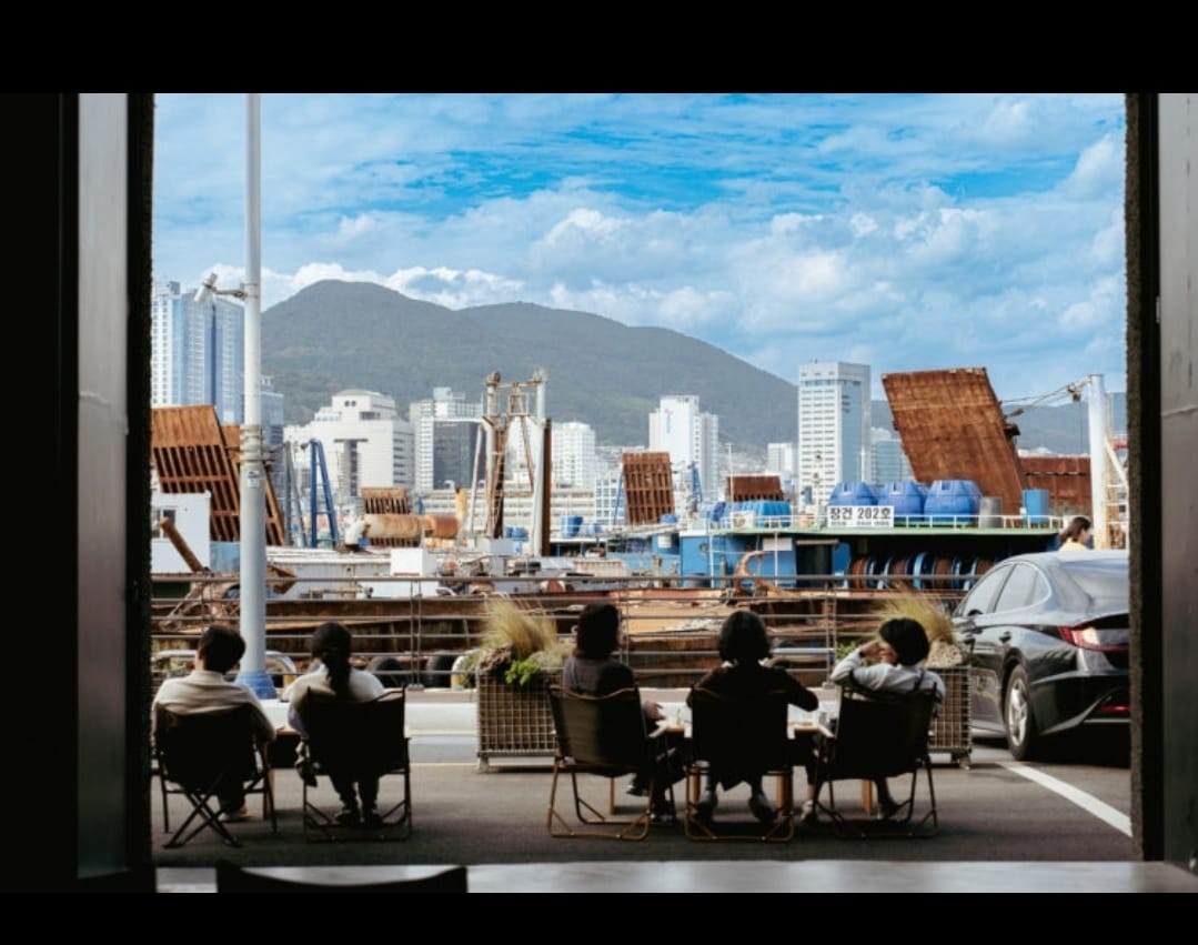 Inside a café with a direct view of the shipyard.
