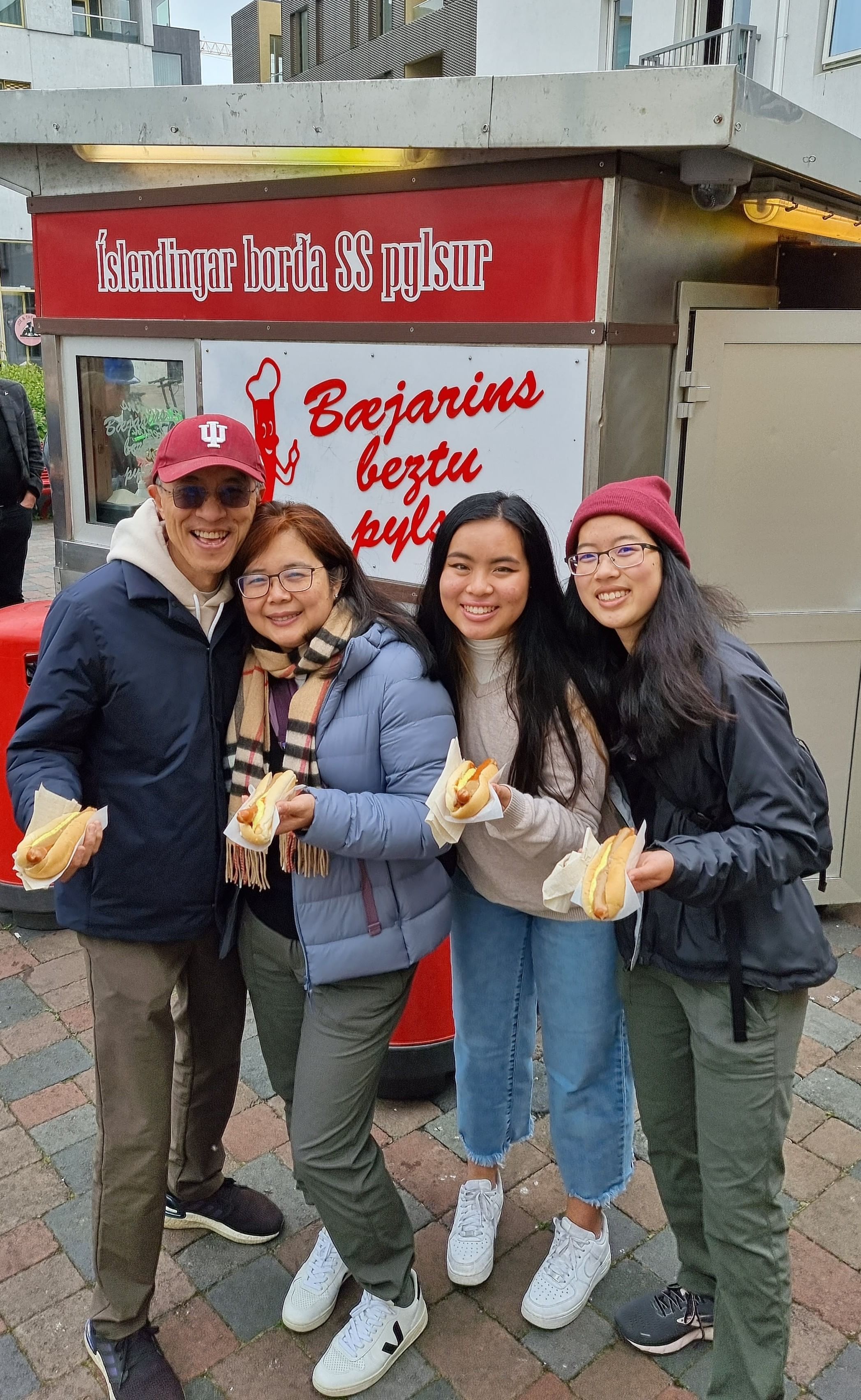 Travelers enjoying a hotdog at the famous hot dog stand in downtown Reykjavik
