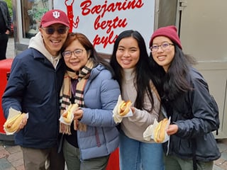 Travelers enjoying a hotdog at the famous hot dog stand in downtown Reykjavik