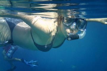 Woman snorkeling underwater in the clear blue waters of Cabo San Lucas