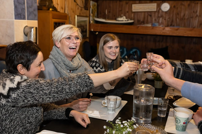 A group of guests enjoying various food items in a restaurant. 