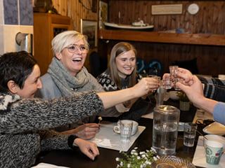 A group of guests enjoying various food items in a restaurant.