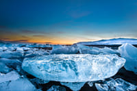 Remaining icebergs on black basalt beach near Glacier Lagoon