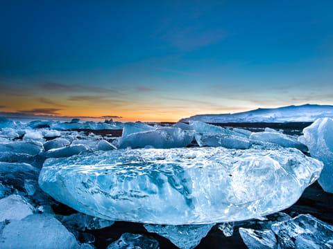 Remaining icebergs on black basalt beach near Glacier Lagoon