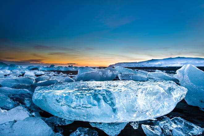 Remaining icebergs on black basalt beach near Glacier Lagoon