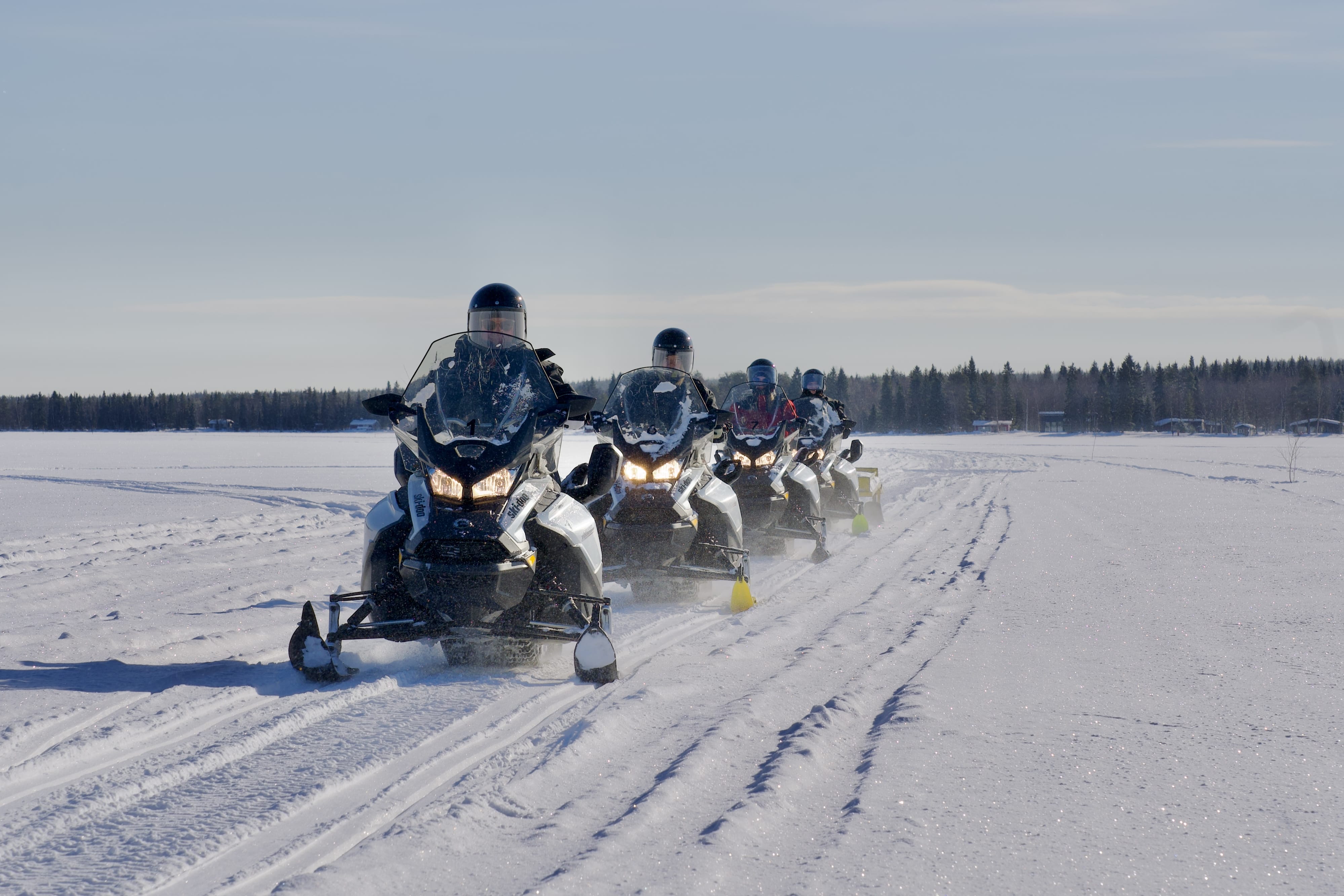 Guests enjoying Ice Fishing with Snowmobiles in Rovaniemi with StayLapland.