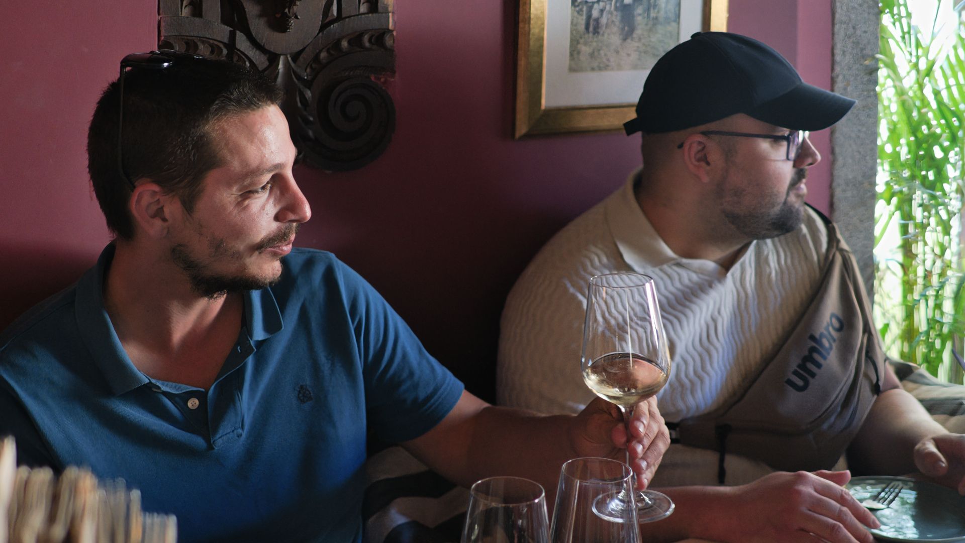 Guests enjoying white wine before a live Fado show in a traditional Porto wine bar