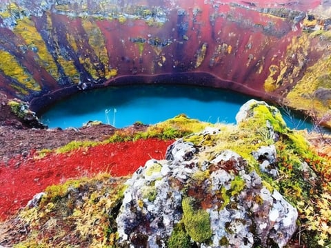 Kerið volcanic crater with striking red rock and blue lake in Iceland