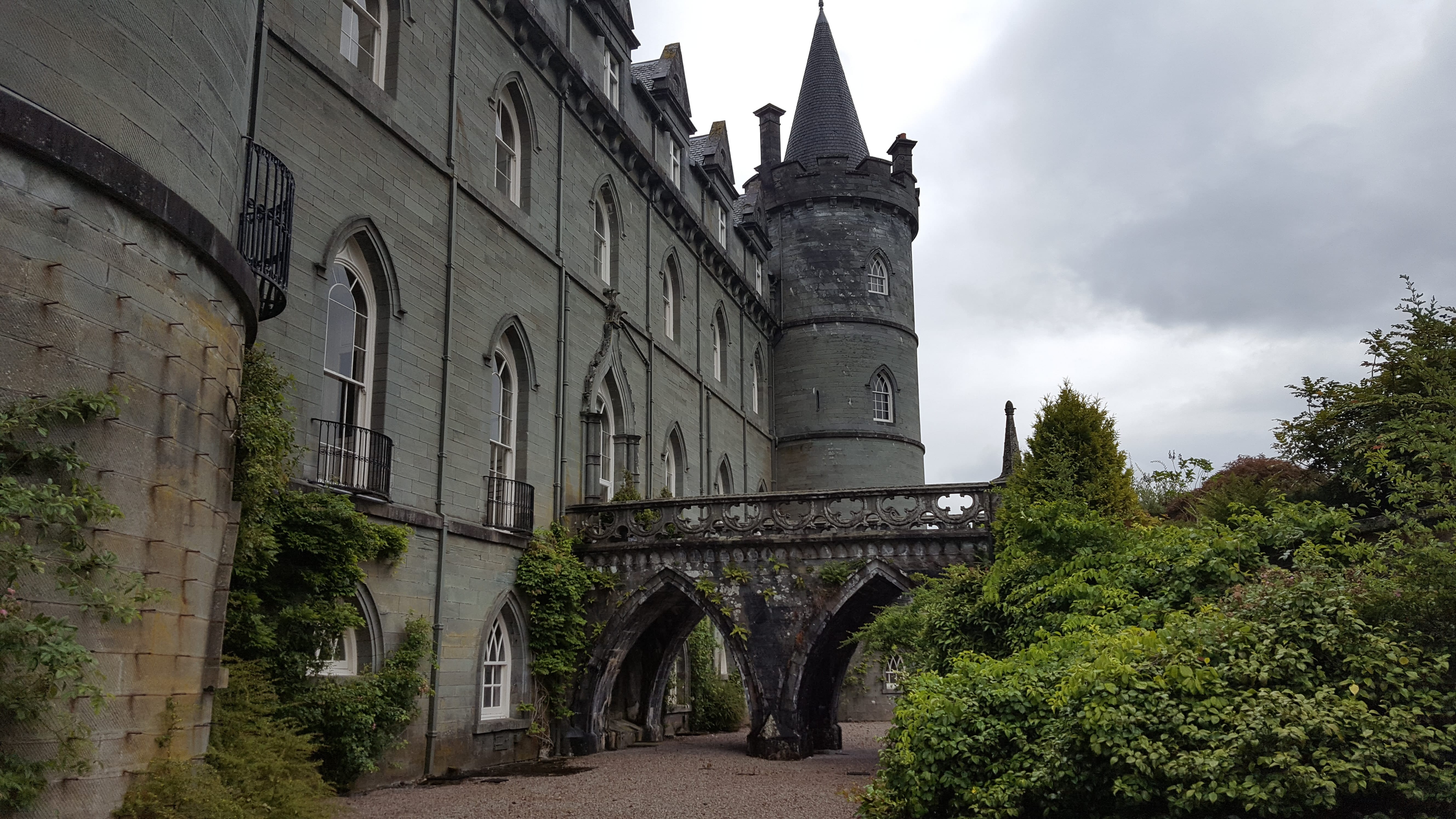 he entrance to Inveraray Castle is flanked by two conical turrets and adorned with detailed stonework, offering a glimpse of its majestic ar