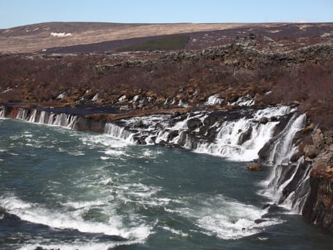 View of Hraunfoss - waterfall that comes from beneath a lava field