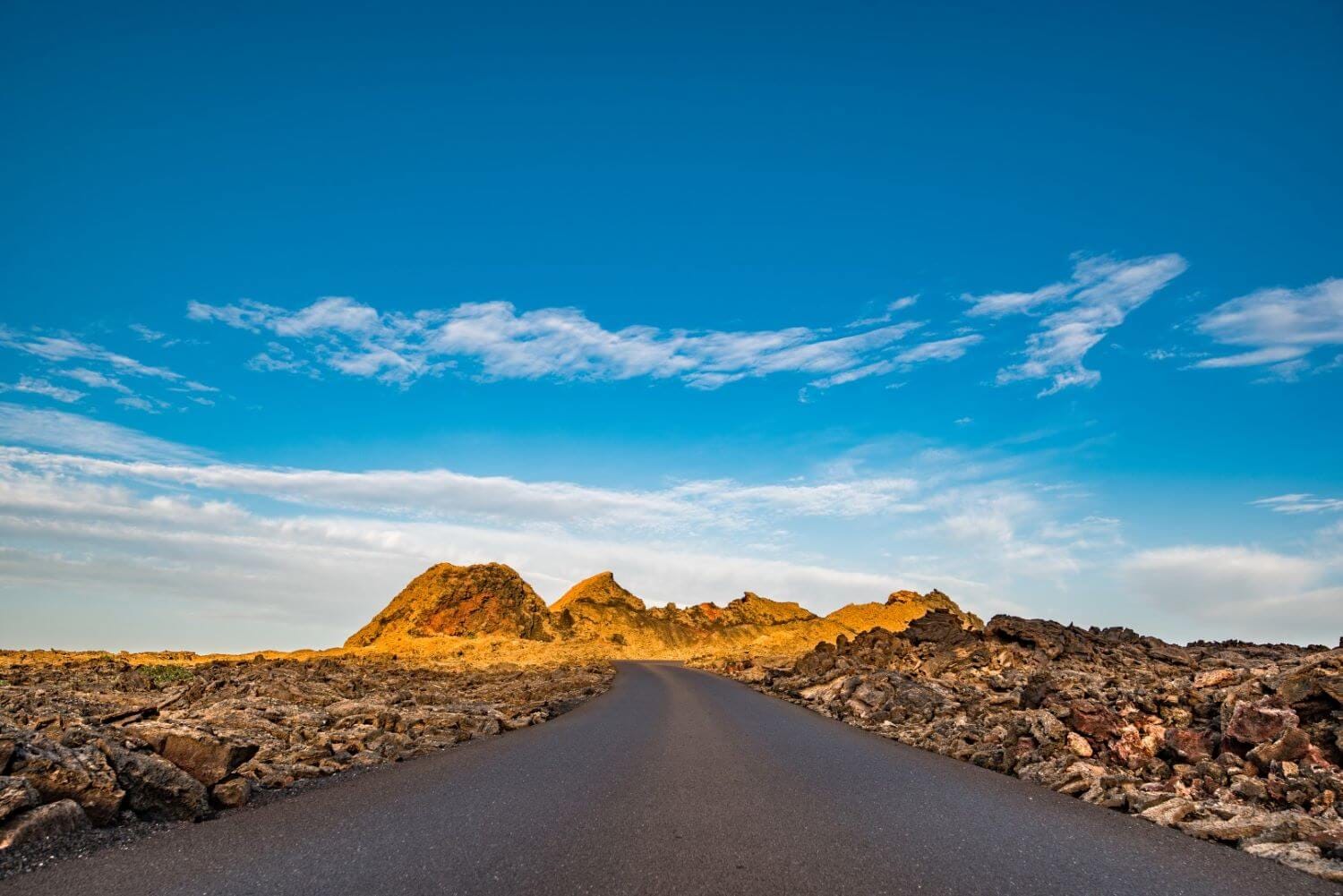 Volcanic mountain landscape in Lanzarote with dramatic peaks and blue sky