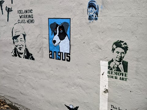 Small graffiti art pieces on a house wall in downtown Reykjavik