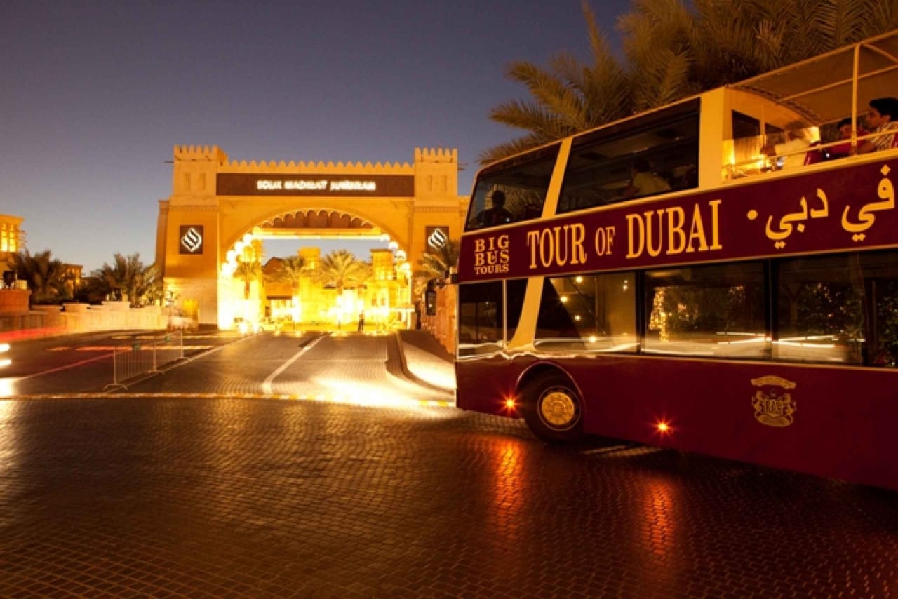 "Dubai's iconic skyline serves as the backdrop for tourists enjoying the Big Bus Tour, a fantastic way to explore."