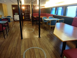 Inside of a boat used to spot Northern Lights, with a comfortable seating area inside