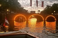Romantic view on the canals of Amsterdam with the lightened up bridges