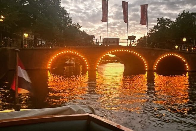 Romantic view on the canals of Amsterdam with the lightened up bridges