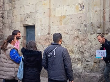 Tour Guide Explaining History Behind the damage from the war
