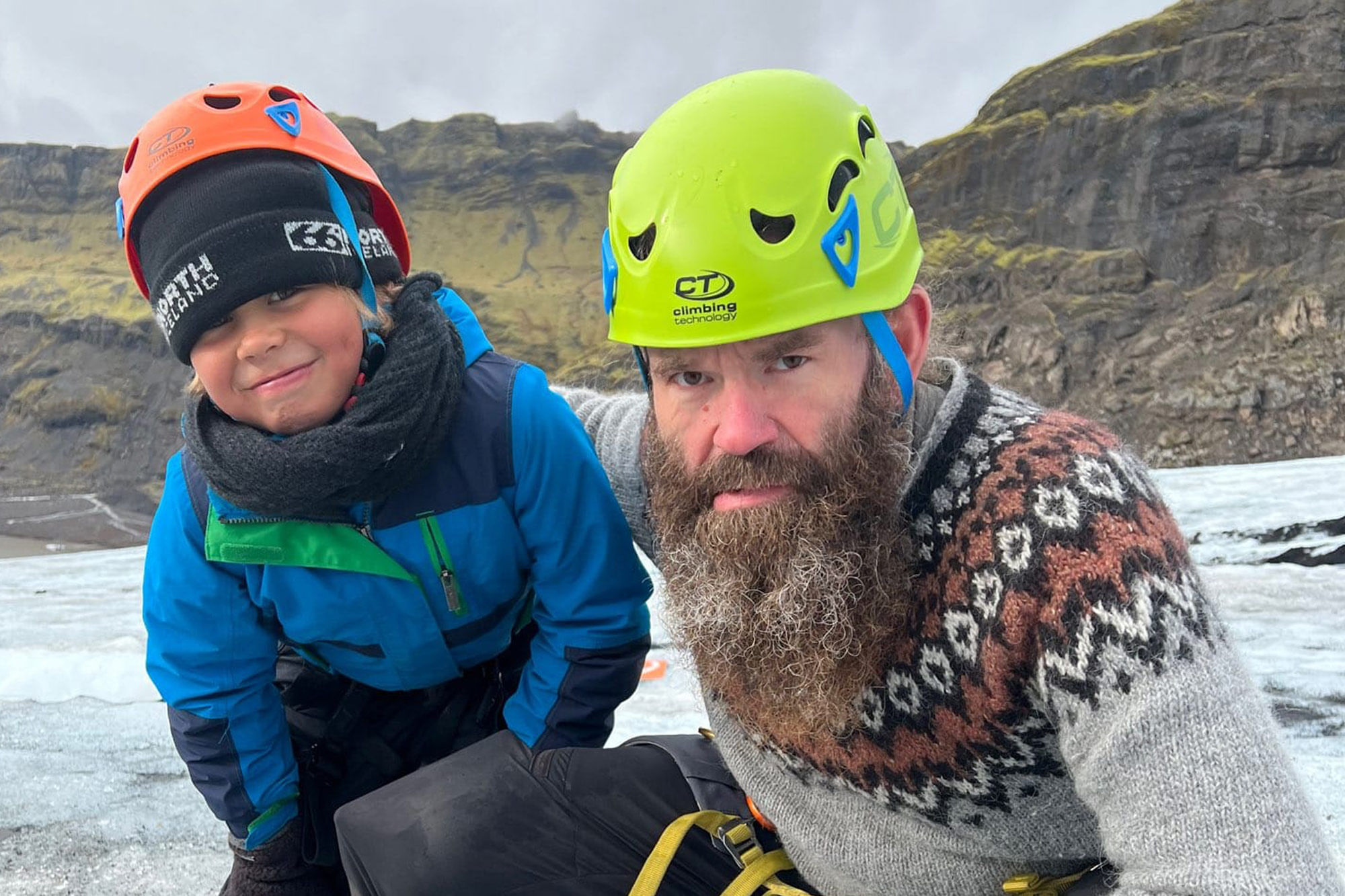 The glacier guide and a boy are making a