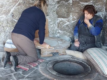 Ann from England first time in her life rolls the lavash bread before baking in the Tonir